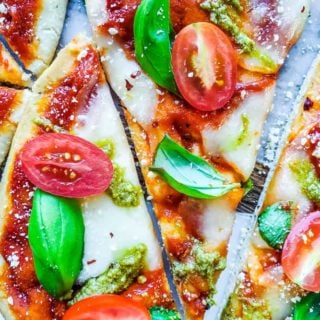 Overhead shot of sliced pizza on a cutting board.