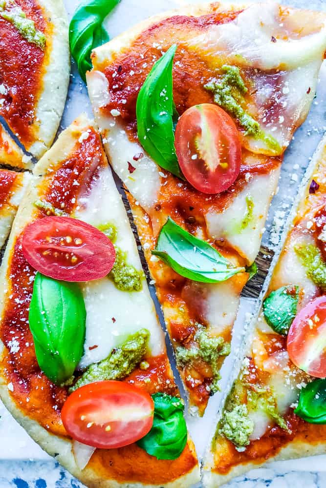 Overhead shot of sliced pizza on a cutting board.