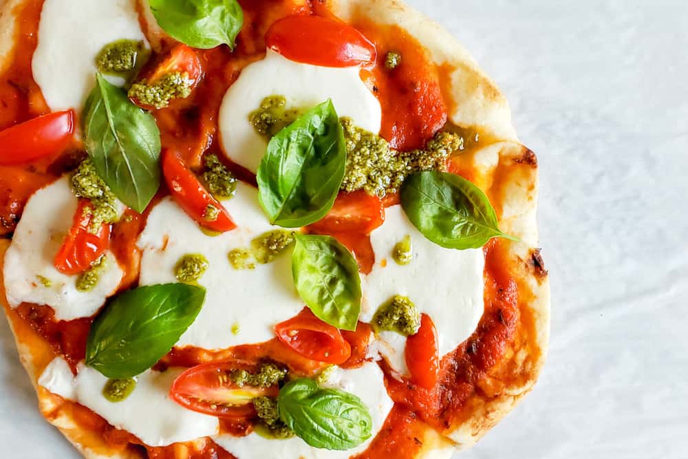 Overhead shot of pizza on parchment paper.