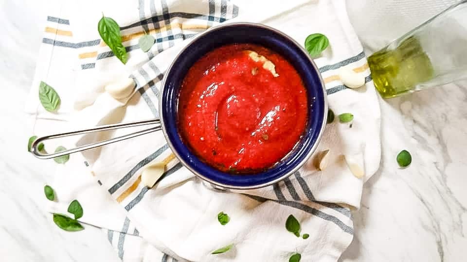 Perfect Marinara Sauce is the perfect combination of garlic and fresh herbs. Ready in under 30 minutes this is the PERFECT universal marinara sauce for pizza, pasta, and as a dip. You will never want to buy pre-made sauce again!