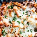 Overhead shot of baked mostaccioli in a glass baking dish.