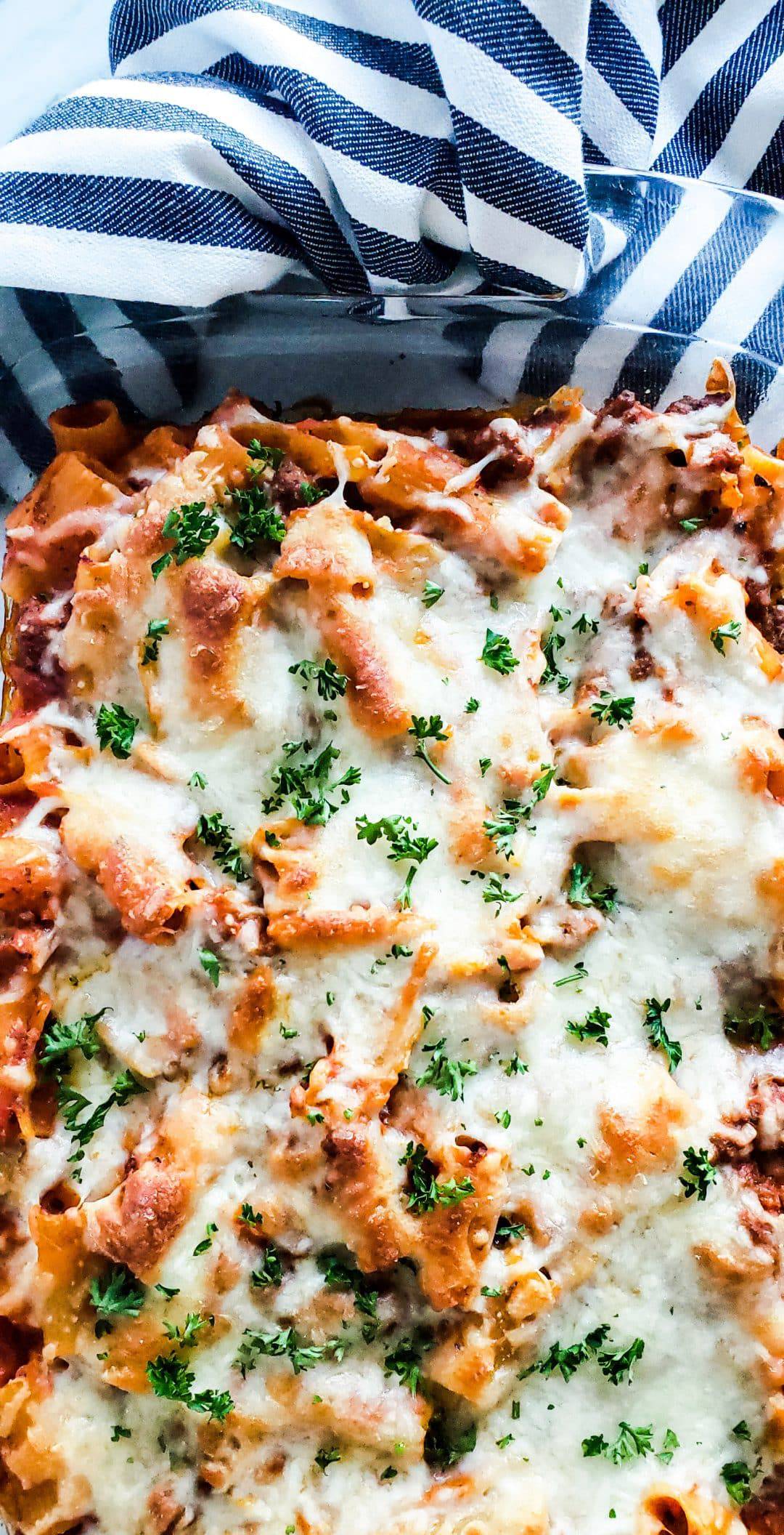 Overhead shot of baked mostaccioli in a glass baking dish.