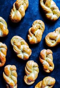 Homemade soft pretzels on a blue counter.