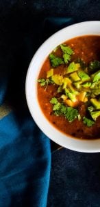 Close up shot of soup in white bowl. Part of bowl is out of frame.