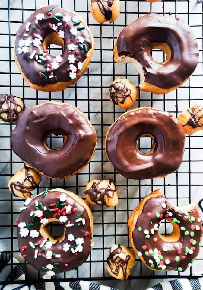 Overhead shot of donuts on a cooling rack.