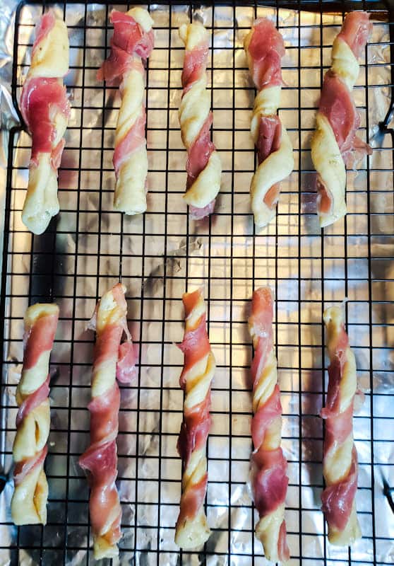 Prep image of unbaked breadsticks on rack.