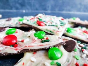 Close up shot for Christmas chocolate bark recipe. The image shows the bark stacked randomly and is focused on one piece in the front. 