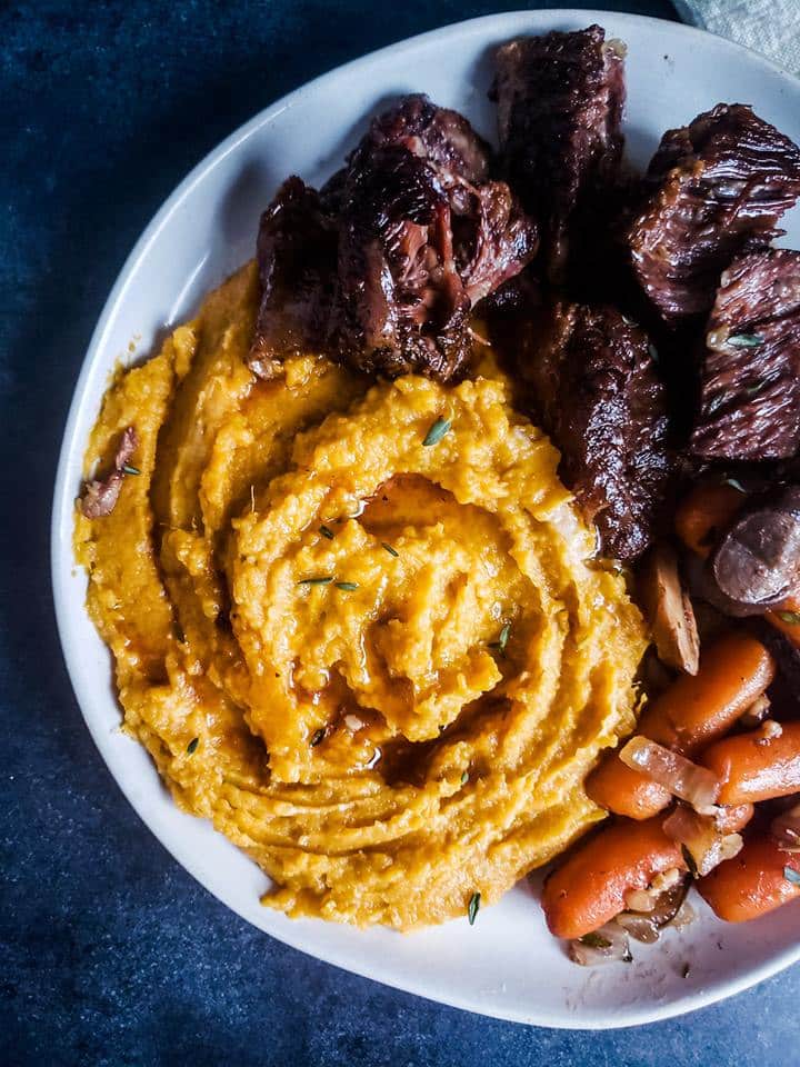 Overhead shot of finished plate with potatoes and ribs.