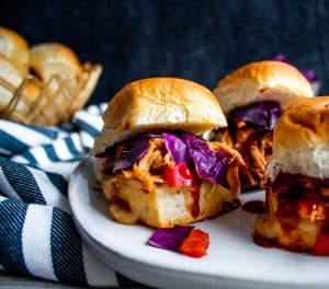 BBG Chicken Sliders on a white plate with striped towel on the left.