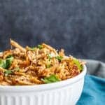 Large white bowl filled with shredded pork.