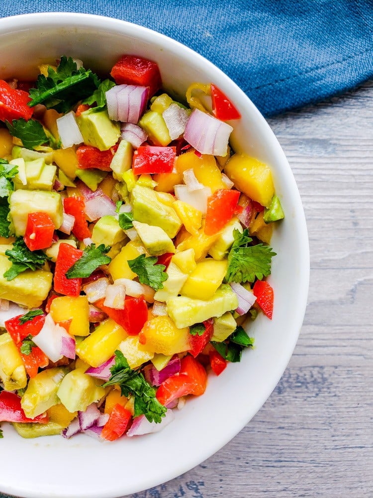 This Easy Mango Avocado Salsa is the BEST fresh summer salsa made with mango, avocado, cilantro, red onion and red pepper. Perfect on its own with chips or paired with your favorite Mexican food like tacos! #salsa #healthy #vegan #vegetarian