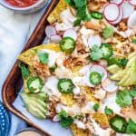 These sheet pan pork carnitas nachos with homemade queso are perfect for a quick and easy weeknight dinner, parties, holidays, or game days! Top with fresh cilantro, jalapeno, and lime for the best finishing touch! #nachos #MexicanFood #pork #food