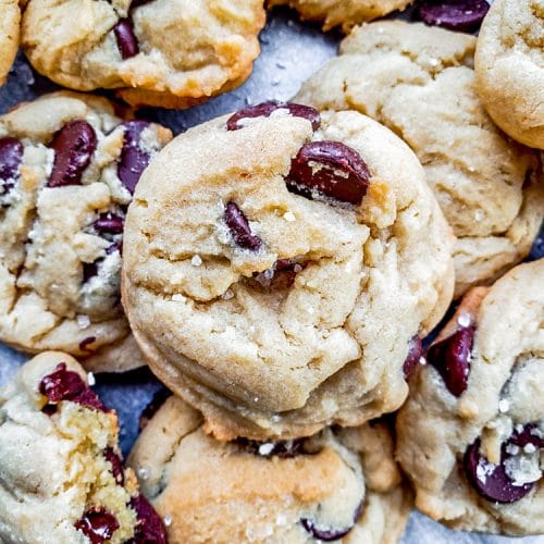 This Salted Chocolate Chip Cookie recipe is the best treat for any occasion including holidays, birthdays, or for a school treat. Packed with dark chocolate chips and topped with a hint of sea salt these cookies are easy and require no chilling. #baking #desserts #cookies