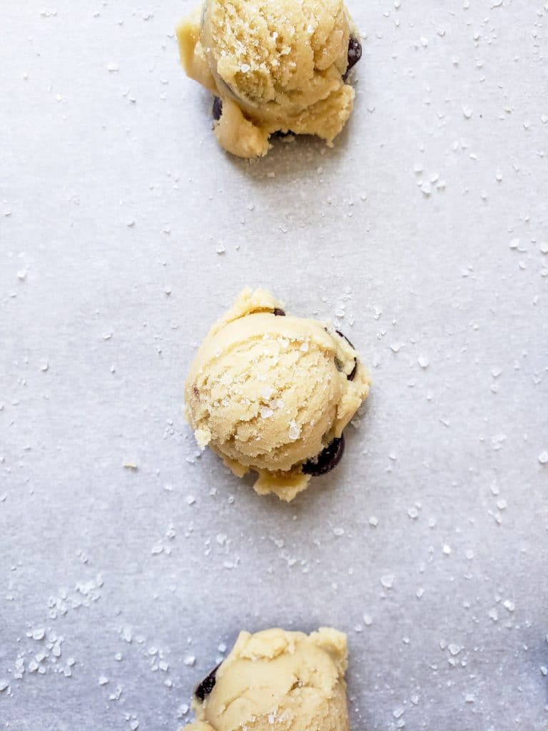Overhead shot of 3 cookie dough balls in a line.