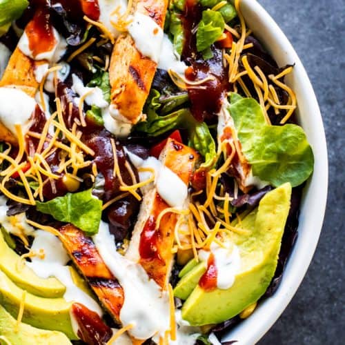 This Grilled BBQ Chicken Salad with Homemade Buttermilk Ranch Dressing is the best summer grill recipe for friends and family! This healthy meal is tasty, a little spicy and works great as a side dish or main dish. Add your favorite toppings like avocados, cheese, black beans, corn, egg, or tomatoes for the perfect touch! Don't have a grill? No problem you can make the chicken on the stove top as well! #salad #BBQ #chicken #recipe #food #healthy #under30minutemeal