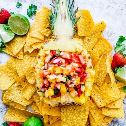 This vegan Strawberry Pineapple Salsa recipe is super healthy, fast and required no cooking! This fresh appetizer is the best for summer BBQ's, holidays, 4th of July, Labor Day or just a gathering with friends and family. #salsa #fruit #strawberries #easyrecipe #vegan