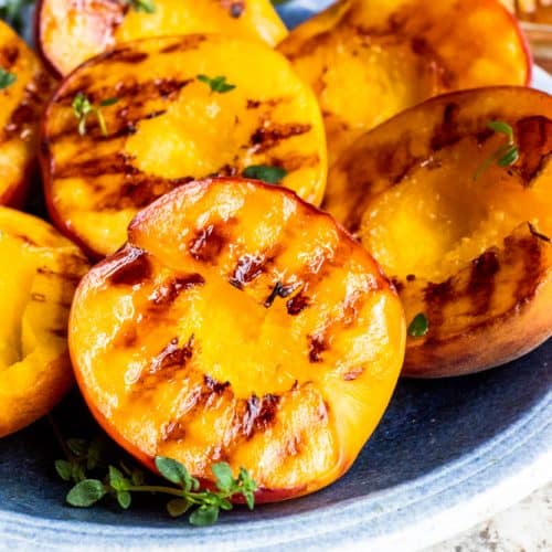 Close up shot of grilled peach on plate.