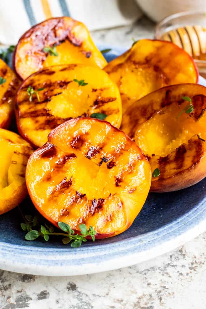 Close up shot of grilled peach on plate.