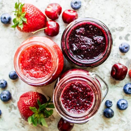 This Easy Jam Recipe is healthy, easy, made with only 3 ingredients (fruit, honey, and chia seeds), made without pectin and ready in only 10 minutes! The best spread for bagels, toast or any breakfast favorite. This recipe is also food sensitivity friendly and is gluten free, nut free, vegan, dairy free, paleo, vegetarian. Enjoy this no canning required blueberry, cherry, and strawberry jam! #jam #vegan #glutenfree #breakfast