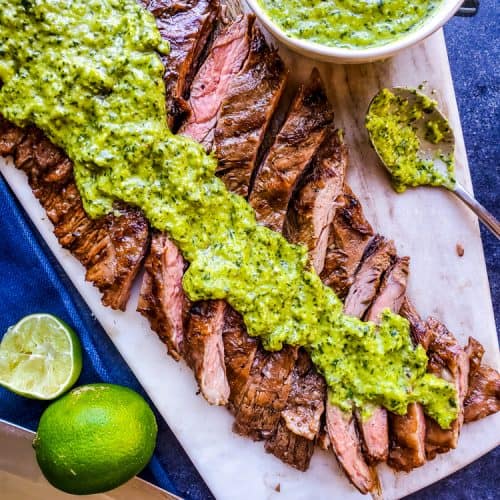 This Grilled Skirt Steak recipe with Chimichurri Sauce is the best summer BBQ recipe for your family and friends! Easy how to steps and tips for tender meat perfect for tacos, fajitas, meal prep, or on its own. The marinade is packed with orange juice, olive oil, soy sauce and garlic and pairs great with so many Mexican dishes. #lowcarb #skirtsteak #BBQ #paleo #keto #food #meatrecipes #dinnerrecipes