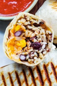 This healthy and easy Vegetarian Burritos recipe is freezer friendly, perfect for meal prep, to make ahead, and super delicious. Packed with black beans, brown rice, quinoa, veggies, cheese and Mexican spices this will be a new family dinner or lunch favorite. Pair with salsa, sour cream or guacamole for the best finish! {VIDEO} #burritos #vegetarian #healthy #mealprep #freezermeal