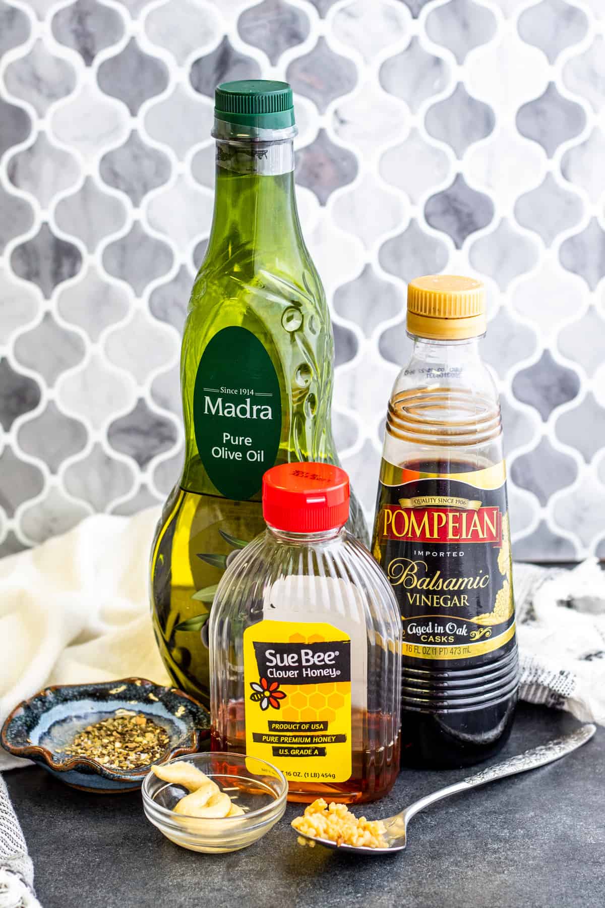 Ingredients for dressing laid out on dark blue table.