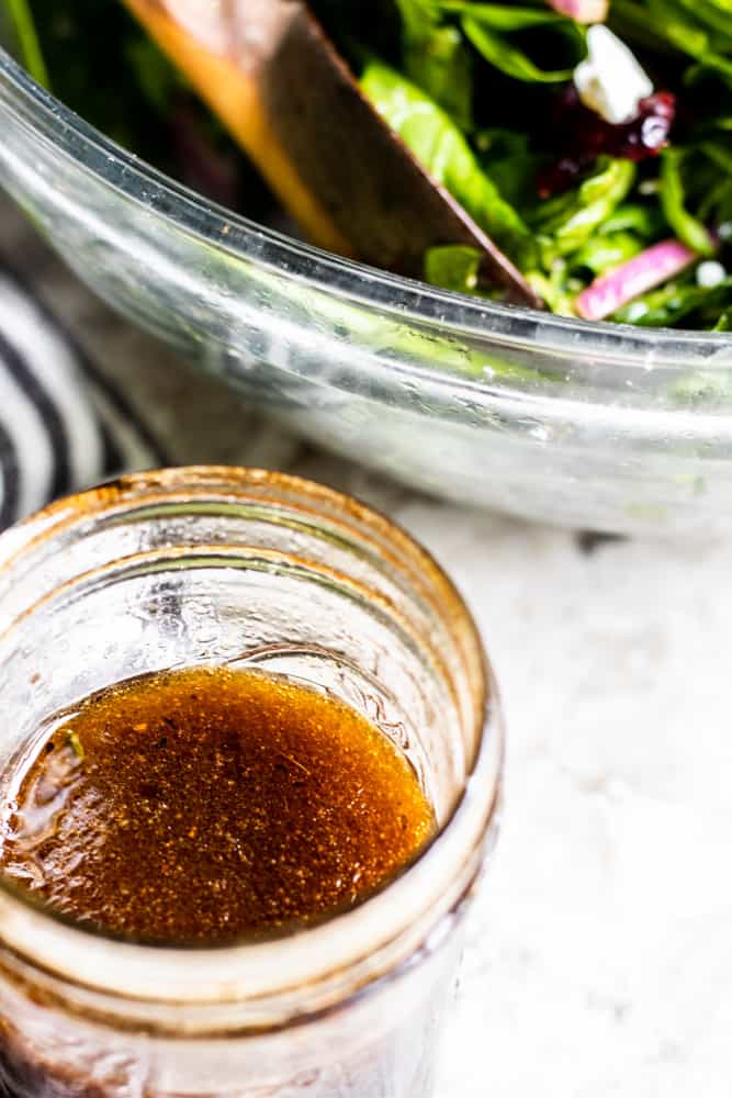 Balsamic Honey dressing in a glass mason jar sitting on a white counter.