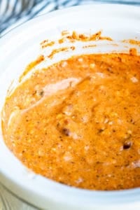 Crockpot chili cheese dip in a white slow cooker.