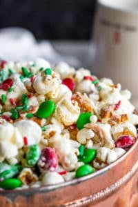 Close up of popcorn snack in a copper tin with a dark blue background.