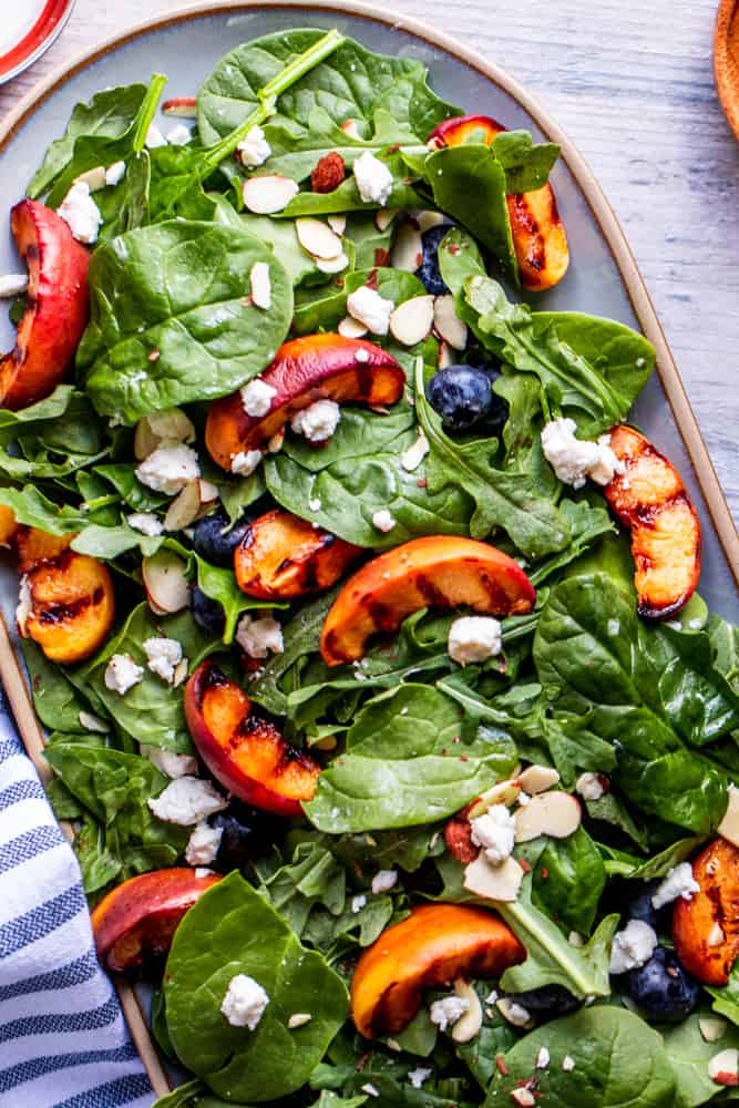 Overhead shot of peach salad on a white counter.