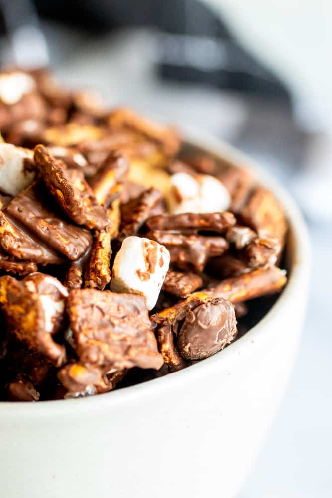 Close up shot of s'mores mix in white bowl on white counter.