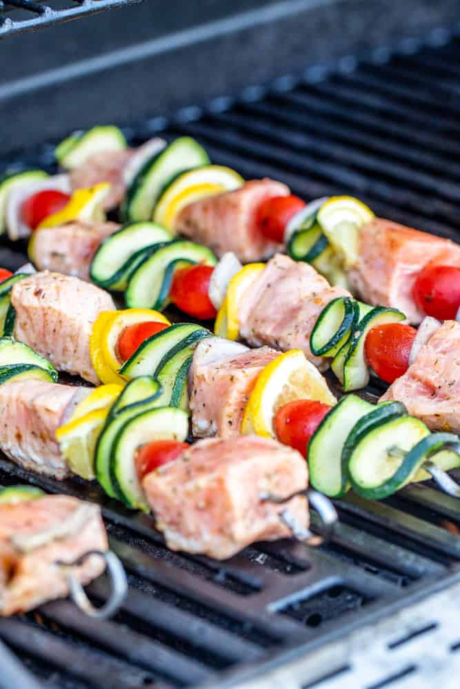 Skewers cooking on an outdoor grill.