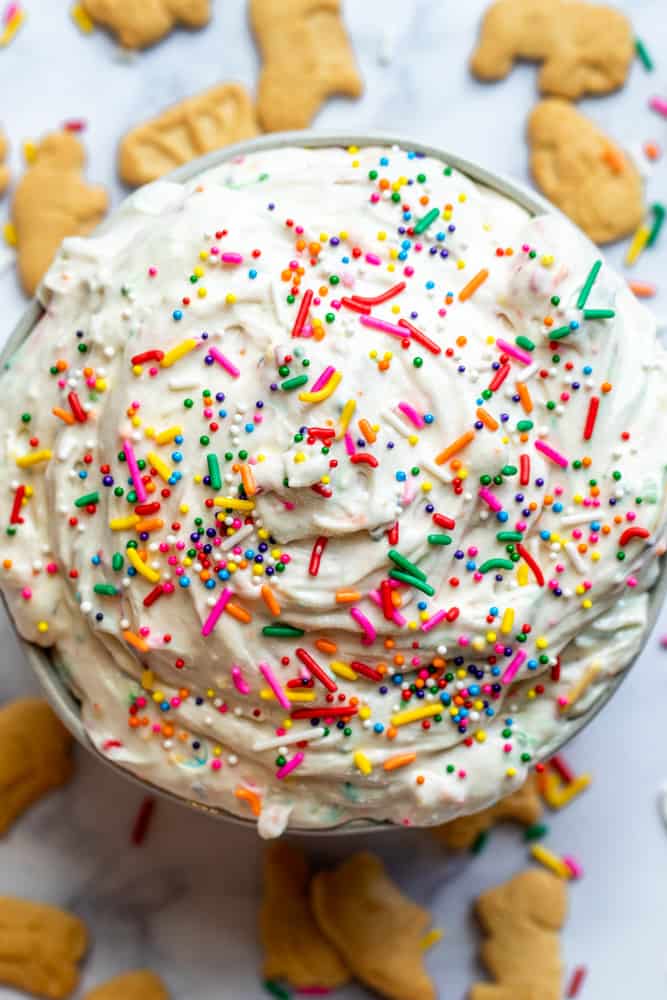 Overhead shot of funfetti dip in a white bowl with crackers around it.