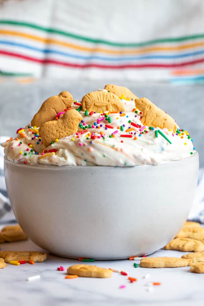 Strait on shot of dunkaroo dip in a white bowl on a white counter.