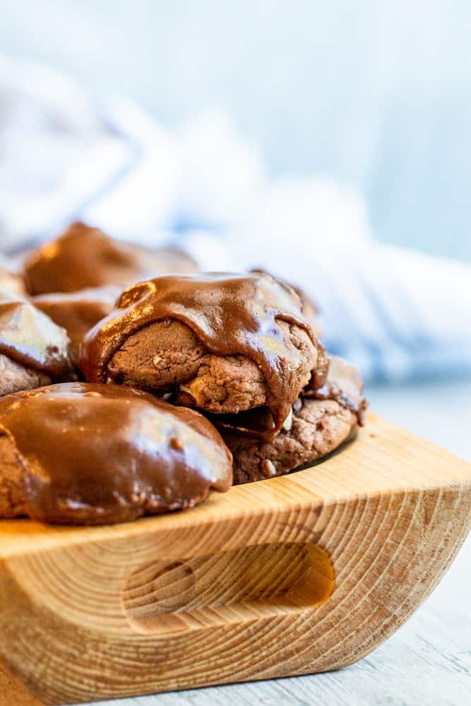 Wooden bowl holding cookies stacked on top of each other.