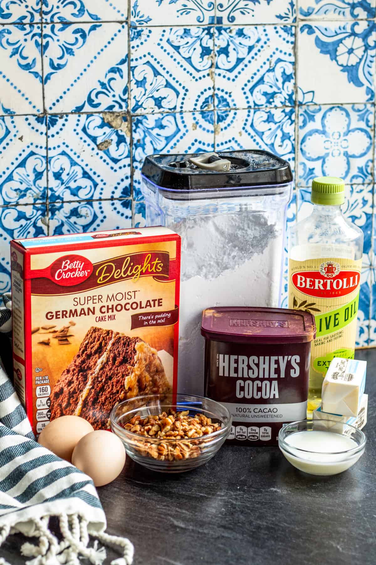 Cookie ingredients laid out on dark counter.