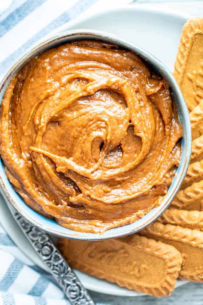 Overhead shot of cookie butter in a bowl with cookies on the side.