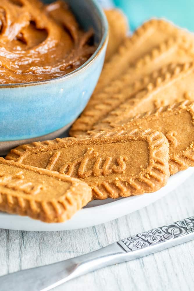 Cookies on white plate with bowl of spread.