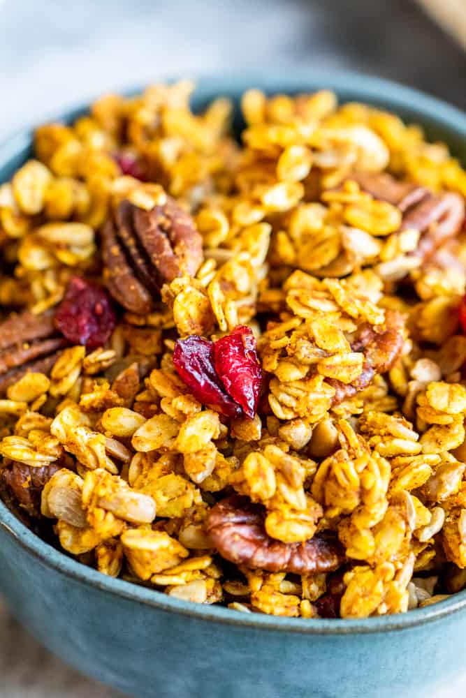 Close up of granola in blue bowl.