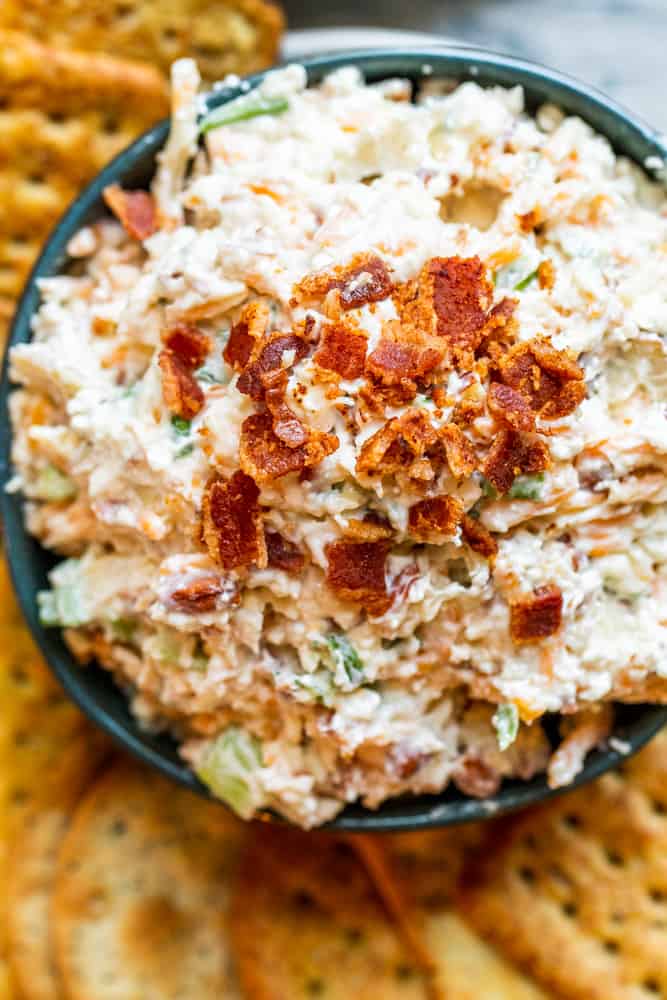 Overhead shot of dip in blue bowl with crackers on the side.