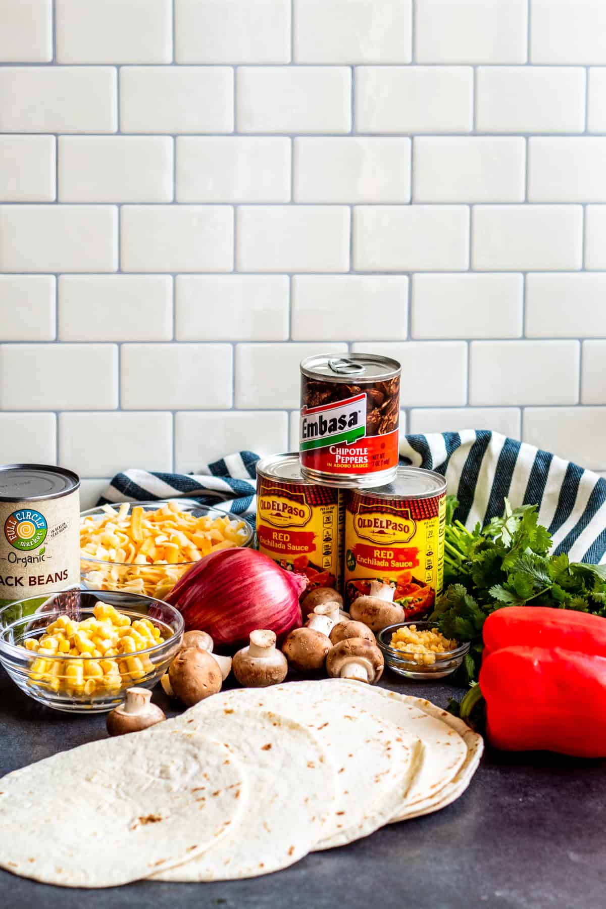 Mexican lasagna ingredients laid out on table.