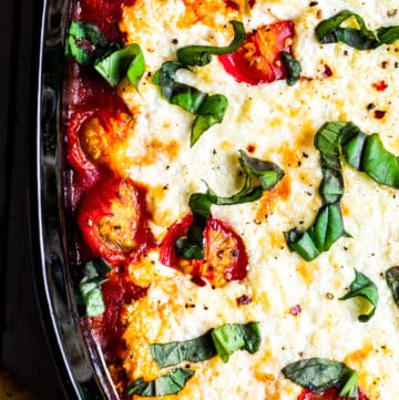 Overhead shot of goat cheese dip in black baking dish.