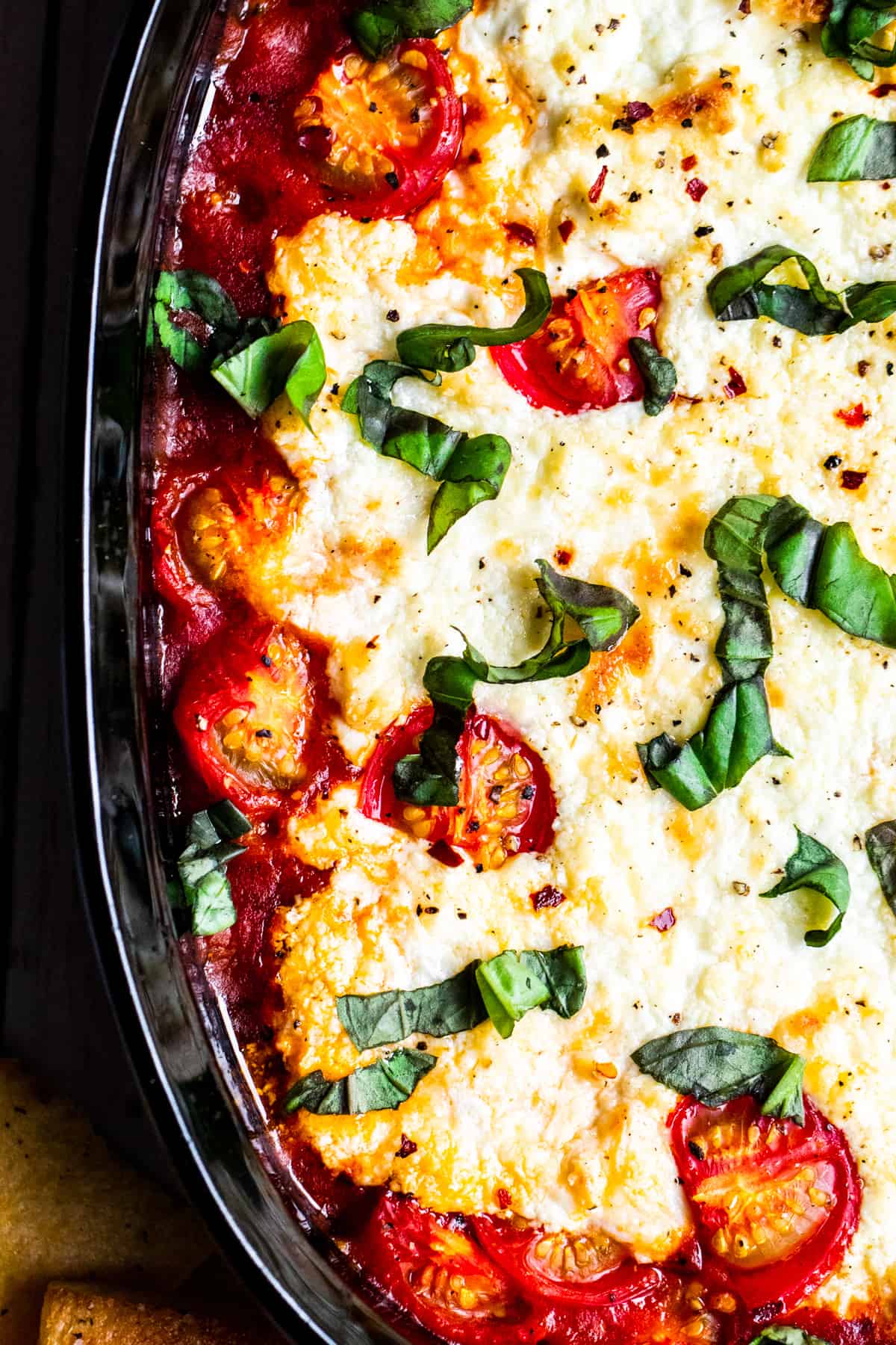 Overhead shot of goat cheese dip in black baking dish.