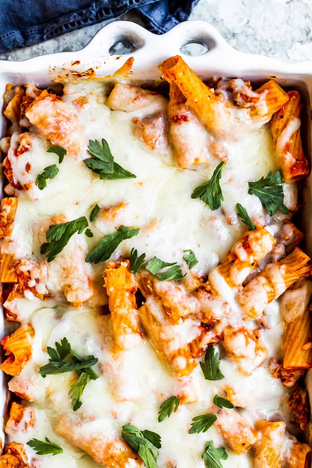 Overhead shot of pasta in baking dish on white counter.