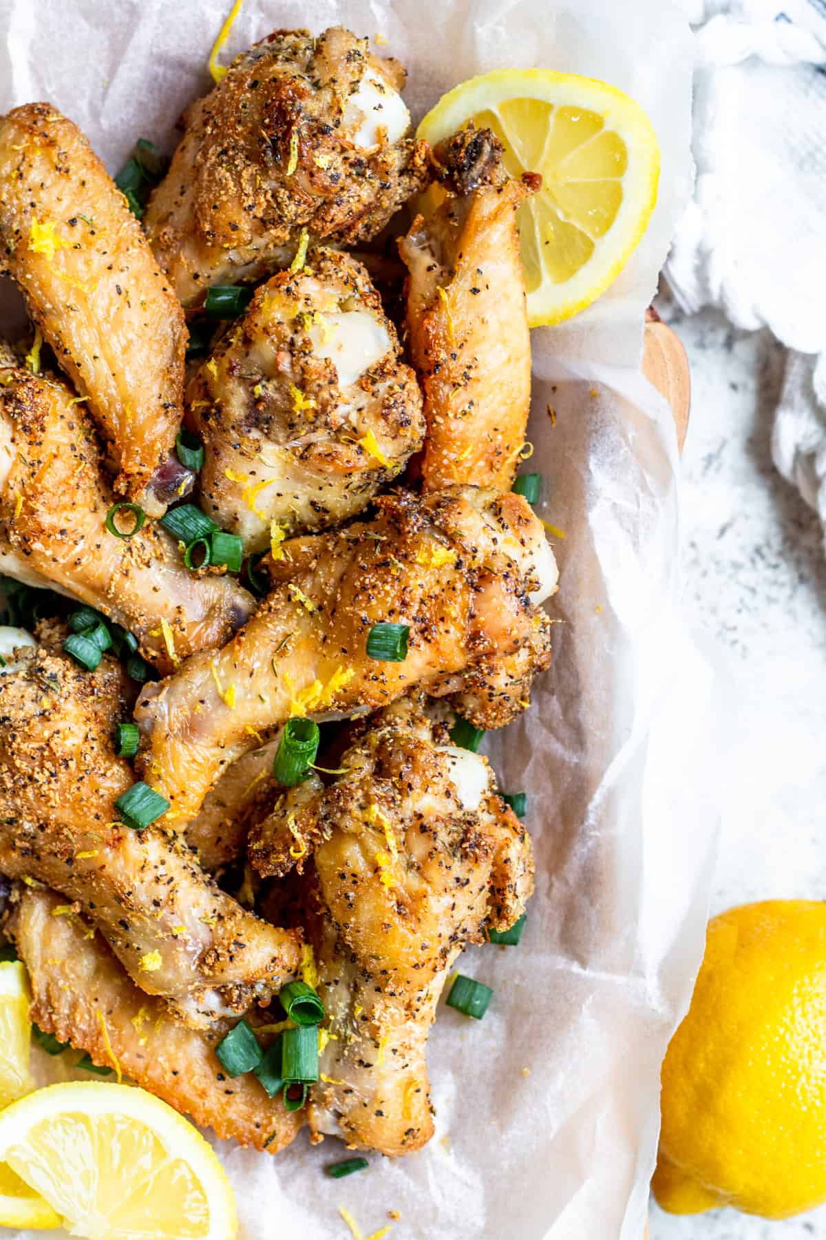Overhead shot of chicken wings with lemon slices.