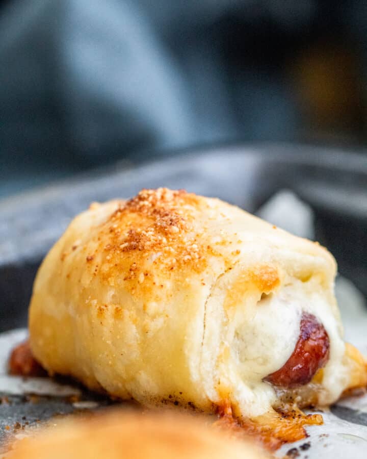 Close up show of pigs in a blanket with parchment paper.