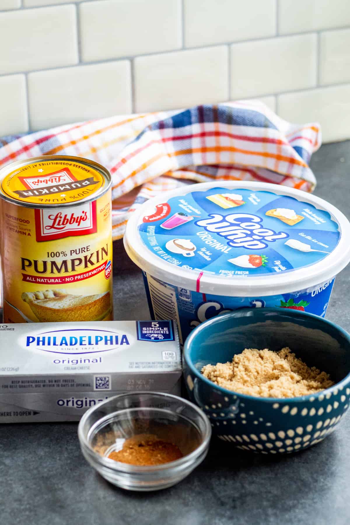 Pumpkin dip ingredients laid out on blue counter.