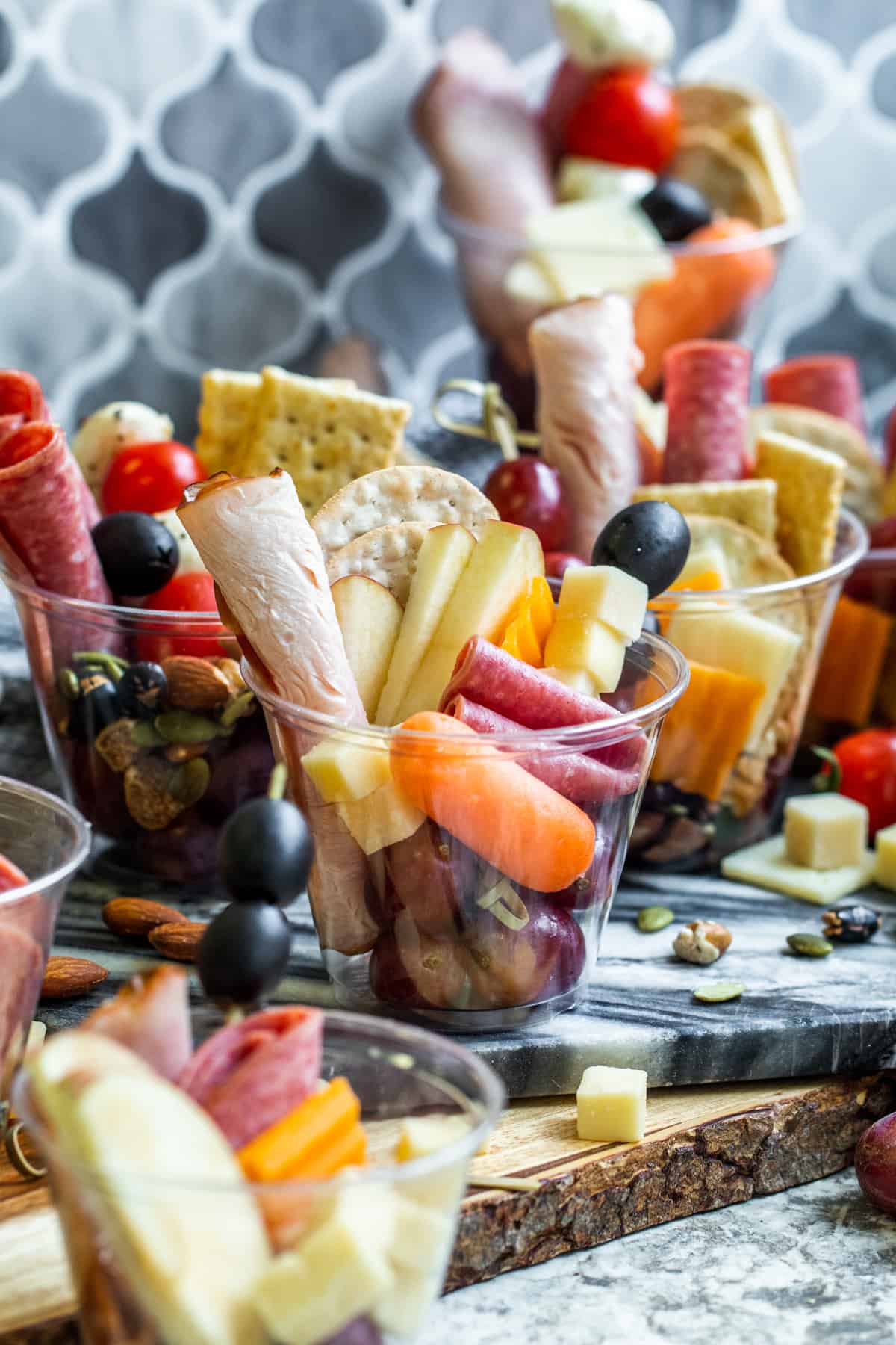 Charcuterie cups scattered on counter.